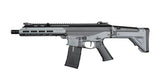 A modern tactical submachine gun with a gray and black finish, featuring a vertical foregrip, adjustable stock, and a mounted rail system on top, shown against a plain white background.
